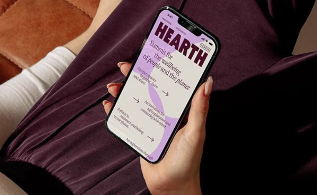Hand holding a smartphone with an open social media feed